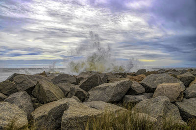 Panoramic view of rocks on land against sky