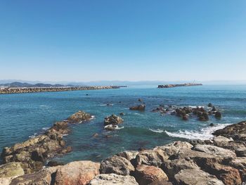 Scenic view of sea against clear blue sky