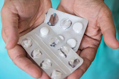 Cropped hand of woman holding blister pack