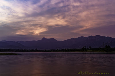 Scenic view of lake against sky at sunset