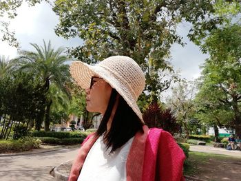 Mature woman wearing hat while looking away in park