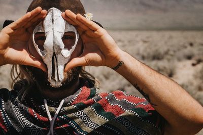 Portrait of man holding animal skull