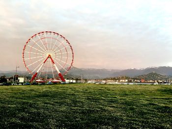 Ferris wheel in amusement park against sky