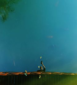 High angle view of man on lake against blue sky