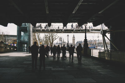 People on bridge in city