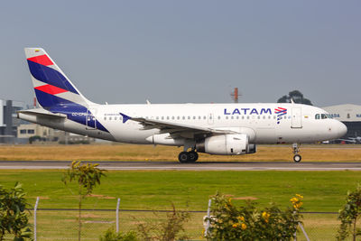 Airplane on airport runway against clear sky