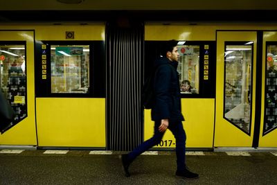 Full length of man standing on train at railroad station