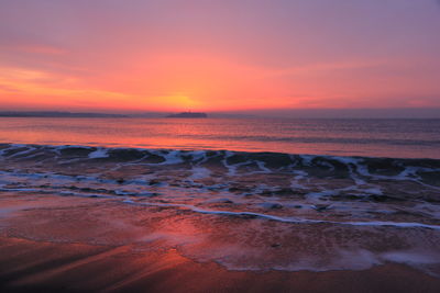 Scenic view of sea against romantic sky at sunset