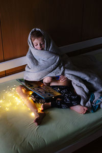 Boy in illuminated room