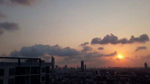 Silhouette buildings against sky during sunset