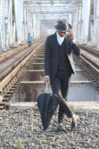 Full length of man on railroad track