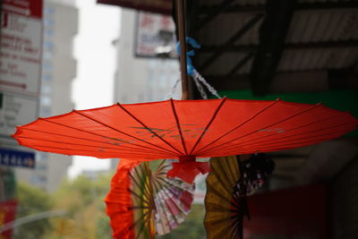 Close-up of red paper umbrella hanging outdoors