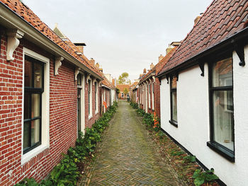 Empty alley amidst buildings in city