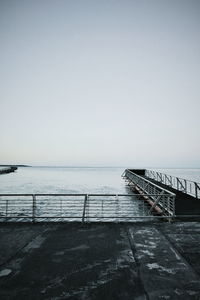 Pier over sea against clear sky