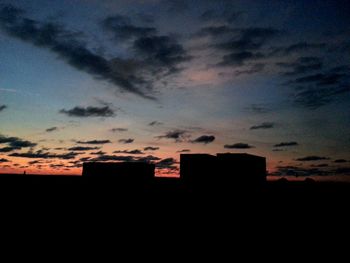 Low angle view of building against sky at sunset