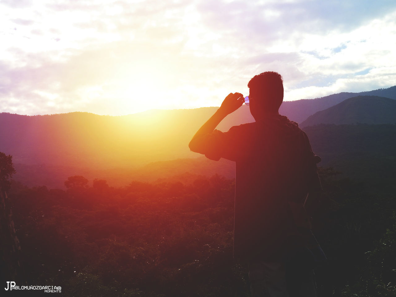 REAR VIEW OF SILHOUETTE MAN PHOTOGRAPHING ON LANDSCAPE AGAINST SKY