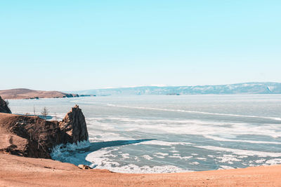 Scenic view of sea against clear sky during winter