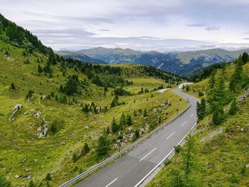 High angle view of road by mountains against sky