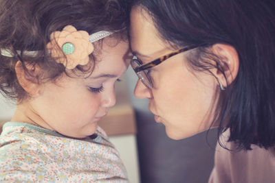 Close-up of mother with daughter at home