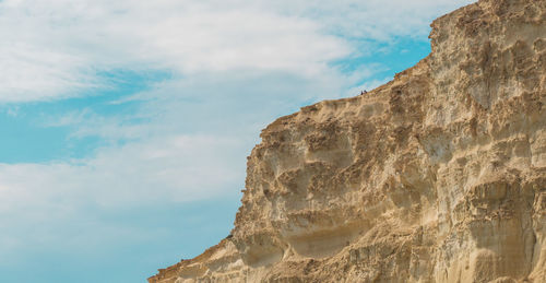 Low angle view of rock formation against sky