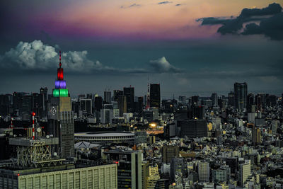 Modern buildings in city against cloudy sky