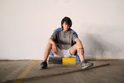 A portrait of a young man standing on the wall