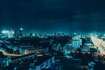 High angle view of illuminated cityscape against sky at night