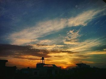 Silhouette of built structure against sunset sky