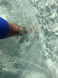 Low section of woman standing in water