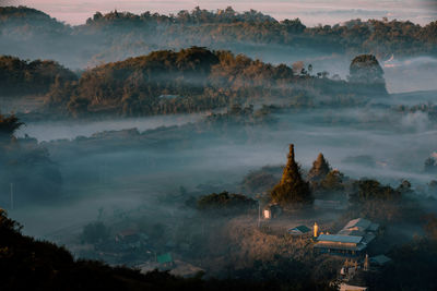 High angle view of trees and mountains against sky