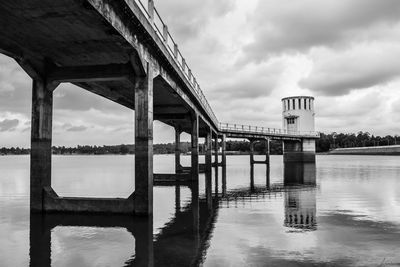 Low angle view of bridge over river against sky