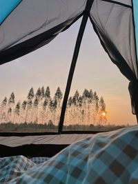 Low section of woman relaxing in tent