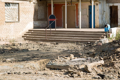 Destroyed entrance building fragments stairs and debris.