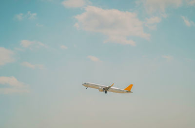 Low angle view of airplane flying in sky