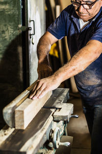 Man working on metal in garage