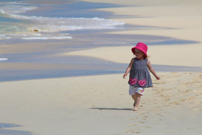 Full length of girl walking on beach