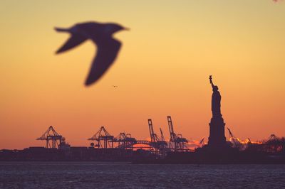 Silhouette of statue at sunset