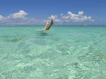 Man surfing in sea against sky