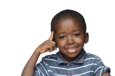 Portrait of smiling boy against white background