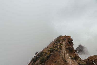 View of footpath against foggy sky