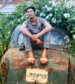 Portrait of smiling young man sitting outdoors