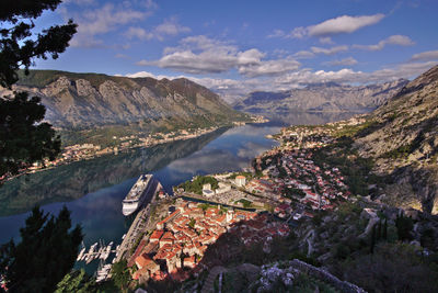 High angle view of townscape by mountains against sky