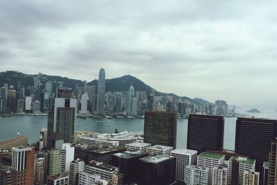 Cityscape against cloudy sky