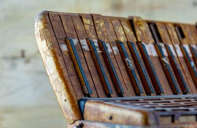 Close-up of old bench in row