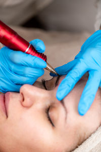 Close-up of woman applying nail