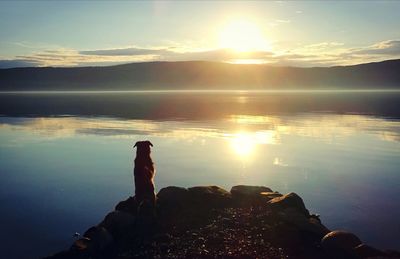 Scenic view of lake against sky during sunset