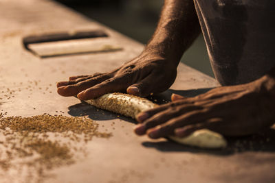 Close-up of man working on sand