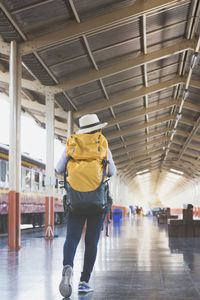 Rear view of people walking in building