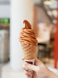 Cropped hand holding ice cream