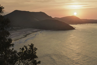 View of calm beach at sunset